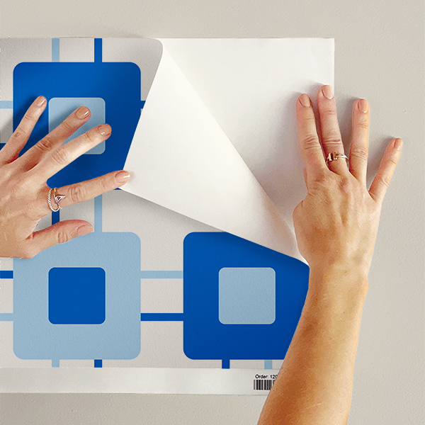 The artwork features a repeating geometric pattern of symmetrical shapes resembling elongated, curved diamonds or petals in various shades of blue and green. Each shape is split vertically with one half filled with a light blue and the other half filled with green or darker blue. The background is a light, almost pastel blue, which provides a soft yet vibrant backdrop. One of the blue shapes near the upper left contains a white starburst element, adding a focal point of brightness to the composition. The overall design conveys a modern, mid-century aesthetic with clean lines and harmonious color contrasts.